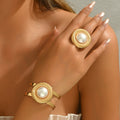 A set of circular bracelets and pearl rings.