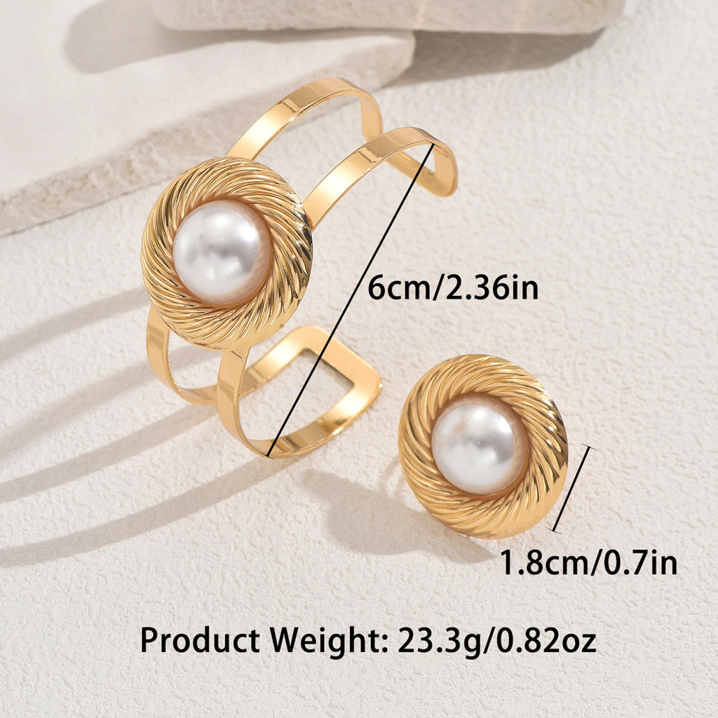 A set of circular bracelets and pearl rings.