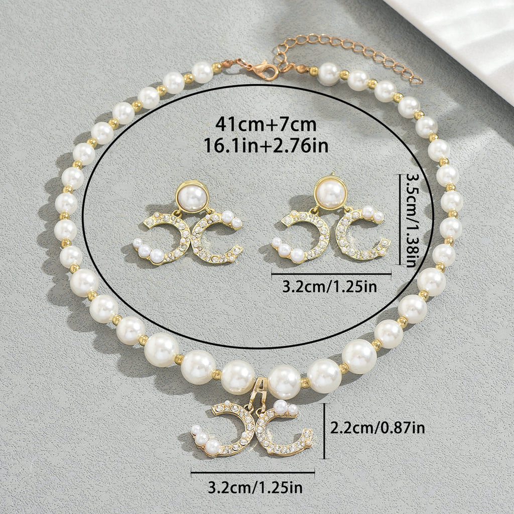 Diamond earrings paired with a long pearl necklace set