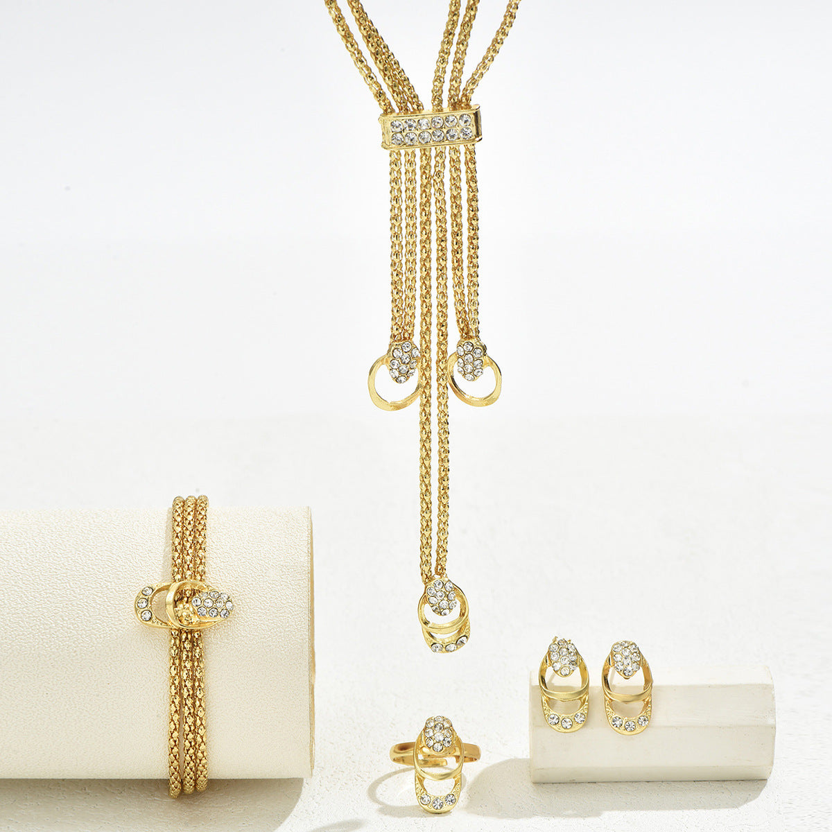 Necklace, earrings, and diamond-encrusted clavicle chain set