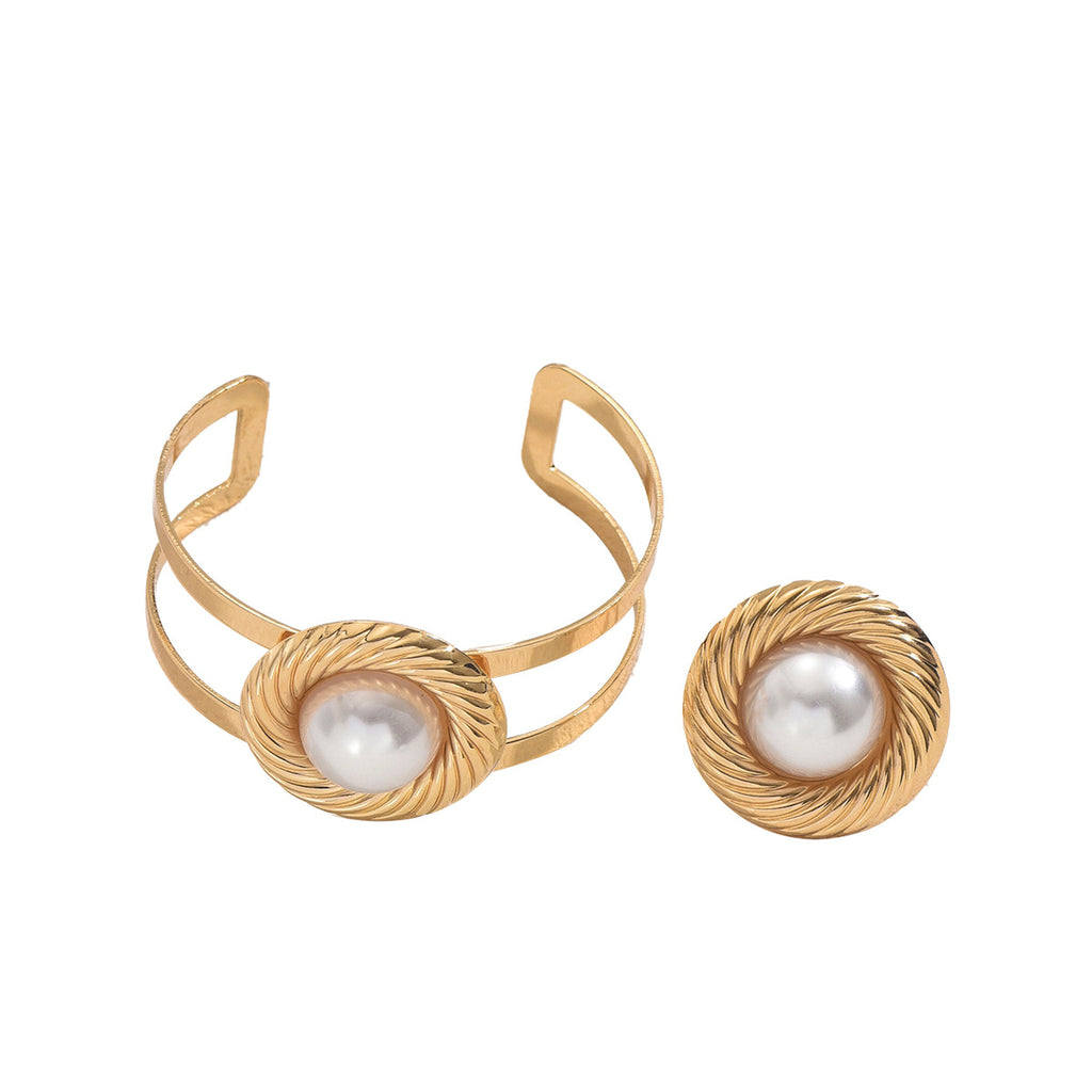 A set of circular bracelets and pearl rings.