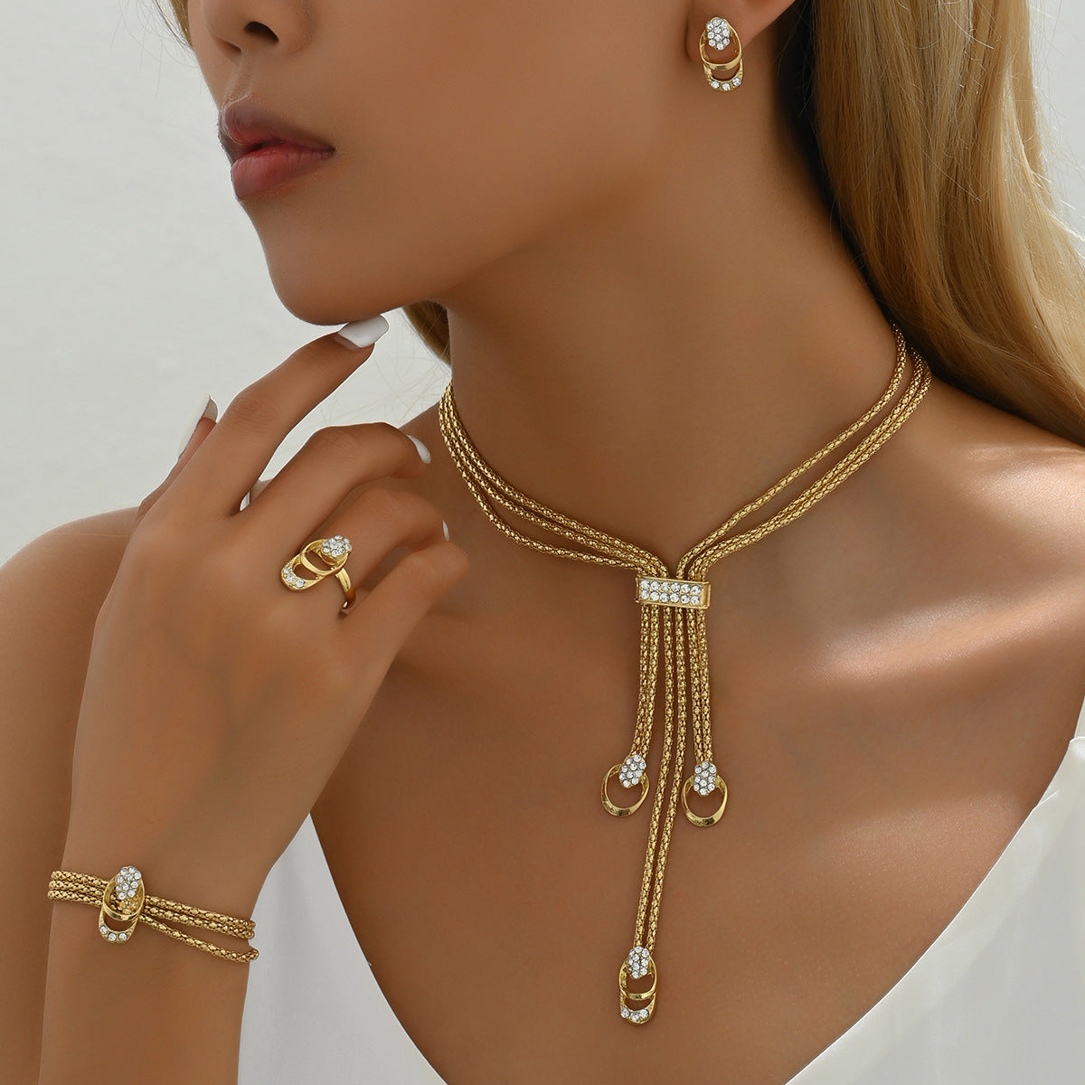 Necklace, earrings, and diamond-encrusted clavicle chain set