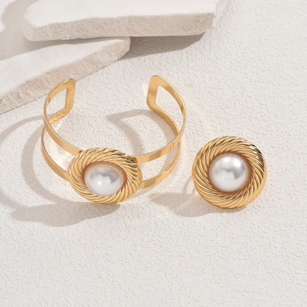A set of circular bracelets and pearl rings.