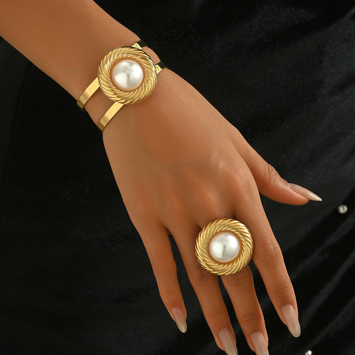 A set of circular bracelets and pearl rings.