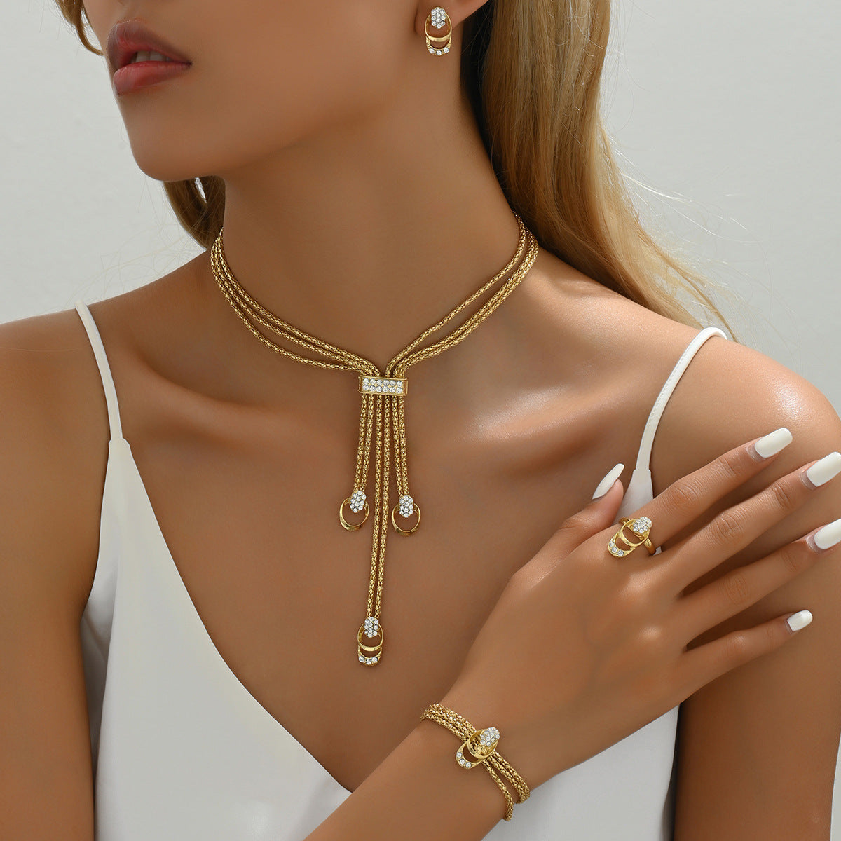 Necklace, earrings, and diamond-encrusted clavicle chain set