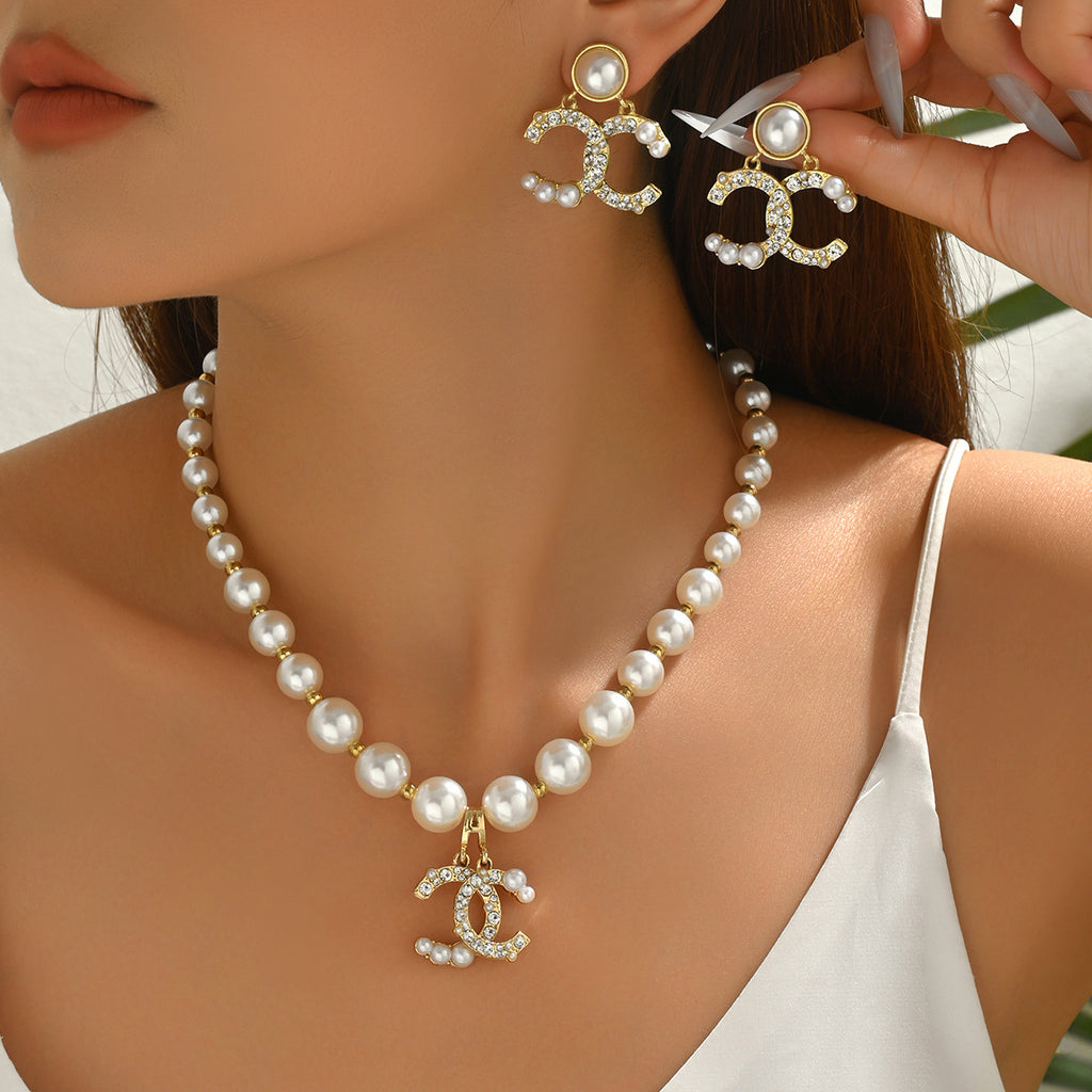 Diamond earrings paired with a long pearl necklace set