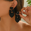 Black heart-shaped high-end stud earrings.